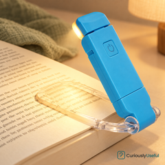 Blue folding book light showing its clear clip and power button.