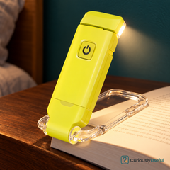 Yellow rechargeable book light clipped to a book.