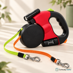 Red dual retractable dog lead with orange and neon green leads, metal clips and built-in LED light.