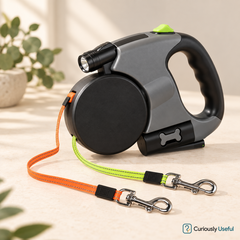Grey dual retractable dog lead with orange and neon green leads, metal clips and built-in LED light.
